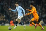 John Stones dan Jude Bellingham dalam laga Liga Champions antara Manchester City vs Real Madrid (Dok. AP Photo)