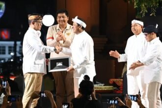 Sugiono menyerahkan KTA Gerindra kepada Bupati Sumedang Dony Ahmad Munir di alun-alun Sumedang, Jumat malam (13/02/2025).