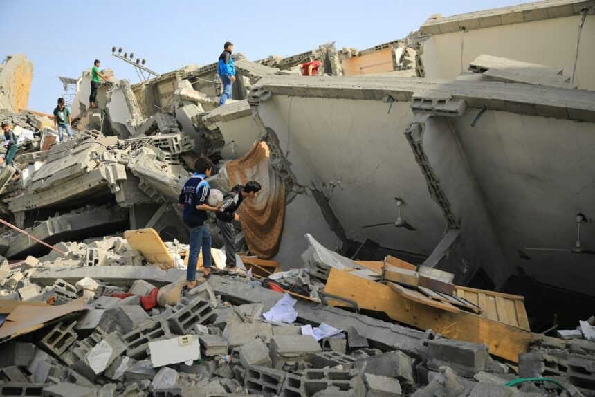 a group of people standing next to a collapsed building